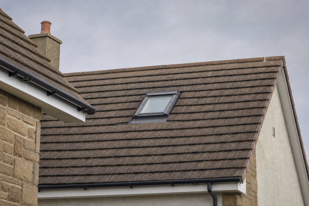 Roof window installed in the pitched tiled roof of a Scottish home